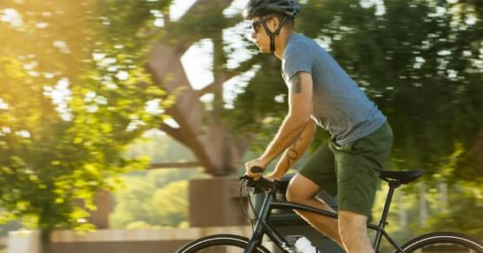 Person stands to pedal a bike