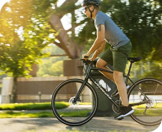 Person stands to pedal a bike